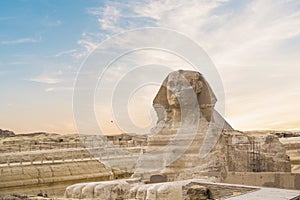 Great Sphinx against the background of the pyramids of the pharaohs Cheops, Khafren, and Mikerin in Giza