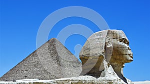 The Great Sphinx of Ghiza with a pyramid in the background. photo