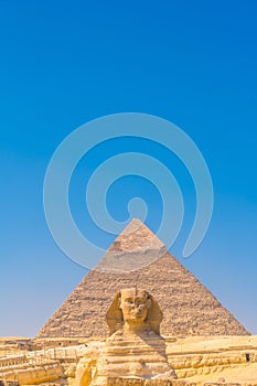 Great Sphinx of Giza and in the background the pyramid of Khafreand  Giza, Cairo, Egypt