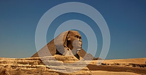 The Great Sphinx of Giza and the Great Pyramid in Cairo, Egypt with clear blue sky