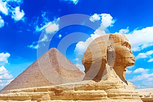 The Great Sphinx and Khafre Pyramid in Giza against blue cloudy sky in Giza, Cairo, Egypt