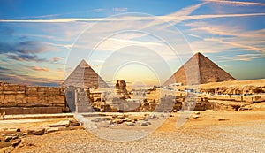 The Great Sphinx next to the Pyramids of Egypt at sunset, Giza desert