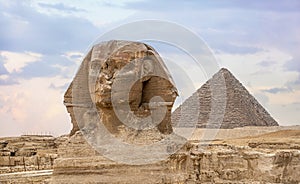 Great Sphinx and Pyramid of Khafre. Sphinx and the Great pyramid in Egypt. The Sphinx in Giza pyramid complex at sunset. ancient