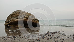 Great stones lying on the sand on the surfboard.