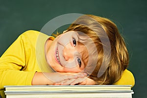 Great study achievement. Funny little boy pointing up on blackboard. Happy school kids. School kids. Kids gets ready for