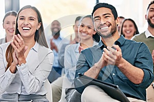 Great stuff. a group of young businesspeople applauding while sitting in the conference room during a seminar.