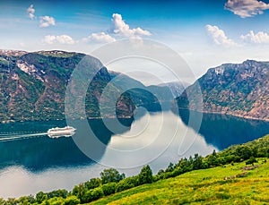 Great summer view of Sognefjorden fjord. Colorful morning scene with Aurlandsvangen village, Norway. Traveling concept background