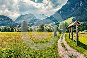 Great summer view of Triglav mountain range and  Gozd Martuljek village. Sunny morning scene of Julian Alps, Slovenia, Europe.