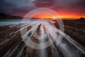 Great sunset over the flysch in Itzurun Beach photo