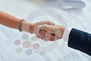 Great things will come from this partnership. two businesspeople shaking hands in an office.