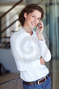 Great to hear from you. an attractive young businesswoman making a call on her mobile phone.