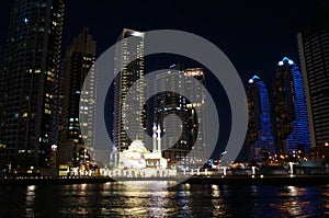 Great view of Dubai city from the water at night. United Arab Emirates.