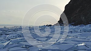 Great view of the evening freeze surface of the iced stones of the reservoir