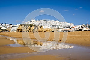 Great view of Fisherman Beach, Praia dos Pescadores, with whitewashed houses on cliff, Albufeira, Algarve, Portugal