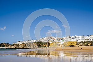 Great view of Fisherman Beach, Praia dos Pescadores, with whitewashed houses on cliff, Albufeira, Algarve, Portugal