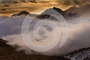 Great view of the foggy valley in Gran Paradiso National Park, Alps, Italy, dramatic scene, colourful autumn morning