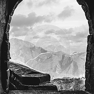 The Great Wall in China, view through a fortress window in black and white