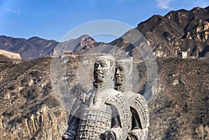 The Great Wall of China in winter. sculptures of ancient warriors on the background of the great wall. The Badaling area.