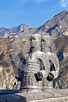 The Great Wall of China in winter. sculptures of ancient warriors on the background of the great wall. The Badaling area.