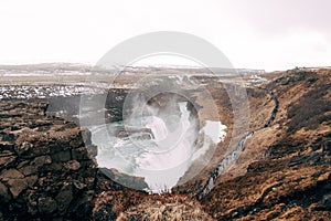 The Great Waterfall Gullfoss in southern Iceland, on the golden ring. Tourists walk on a footpath.