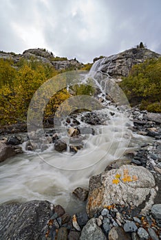 Great waterfall in the mountains in autumn