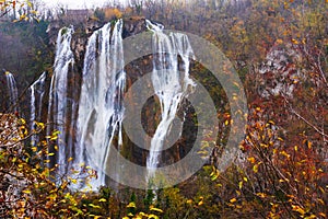 Great Waterfall in Plitvice National Park in Croatia on an autumn day, yellow foliage and turquoise water