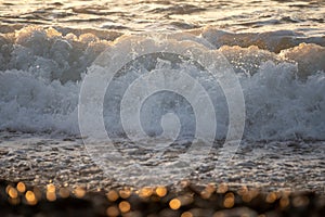 Great wave tide at sunset closeup on the beach