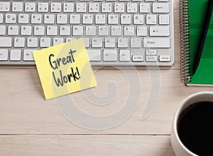 Great work message handwritten on a sticky note paper on the office desk