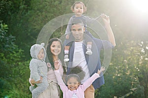 The greatest legacy we can leave our children is happy memories. Portrait of a happy family bonding together outdoors.