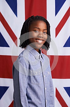The greatest nation. Portrait of a happy young boy standing in front of the Union Jack.