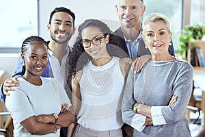 The greatest team. Shot of a group of businesspeople standing in an office at work.