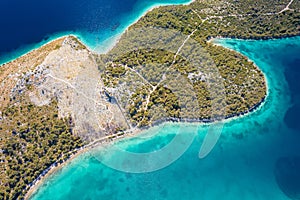 Grebastica turquoise bay and Ostrica historic defence wall ruins aerial view