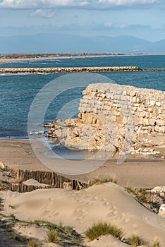 Grec Wall in Platja de Les Muscleres in La Escala behind the ruins of Empuries, in the Province of Giron, Catalonia, Spain.