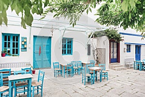 Greece, Amorgos island, Beautiful traditional greek street with flowers and cafe tables
