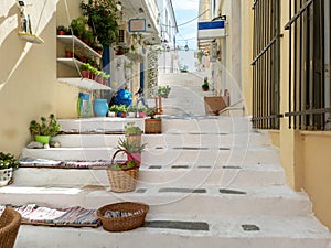 Greece Andros island Cyclades. Souvenir shop pots with plants on stone paved stairs at Chora town