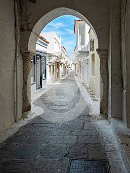 Greece, Andros island, Cyclades. View from arched cover stonewall of houses at Chora town. Vertical