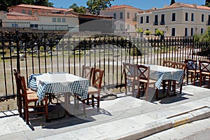 Empty chairs and tables of a traditional restaurant in the touristic district of Plaka