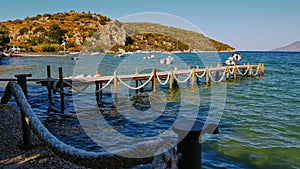 Greece beach foot bridge dock with boats photo