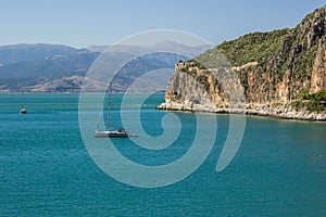 Greece beautiful sea and mountain cape scenic idyllic summer landscape with white small yacht on vivid blue water surface