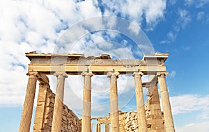 Greece. Colonnade of the Erechtheion temple in the ancient Athenian Acropolis against the blue sky with clouds