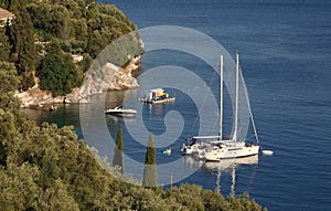 Greece, Corfu island. Top view to the coastline, blue sea and white yacht.