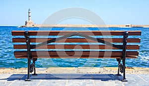 Greece, Crete - Chania port lighthouse behind a bench