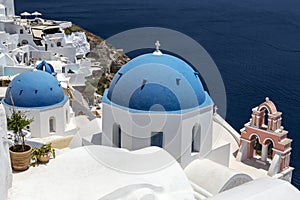 Greece. Cyclades Islands - Santorini Thira. Oia town with typical Cycladic architecture - painted blue cupolas and white walls