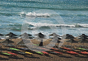 Greece- Empty Beach Scene With Black Umbrellas and Colorful Lounges