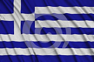 Greece flag is depicted on a sports cloth fabric with many folds. Sport team banner