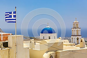 Greece flag over Greek old town on Santorini island.