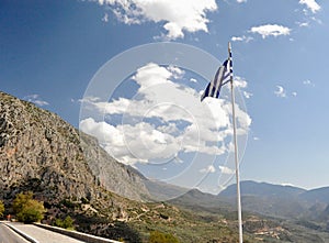 Greece flag and road in mountains to Delfi.