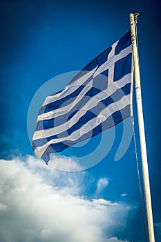 Greece flag on sunny day against cloud in sky