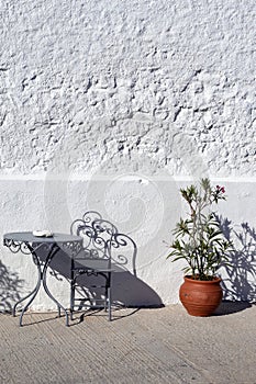 Greece,Folegandros. Chairs, table and plant.