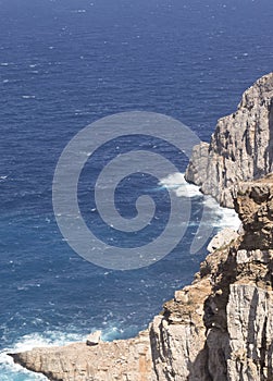 Greece, Folegandros. A sheer cliff face, and the Aegean sea.